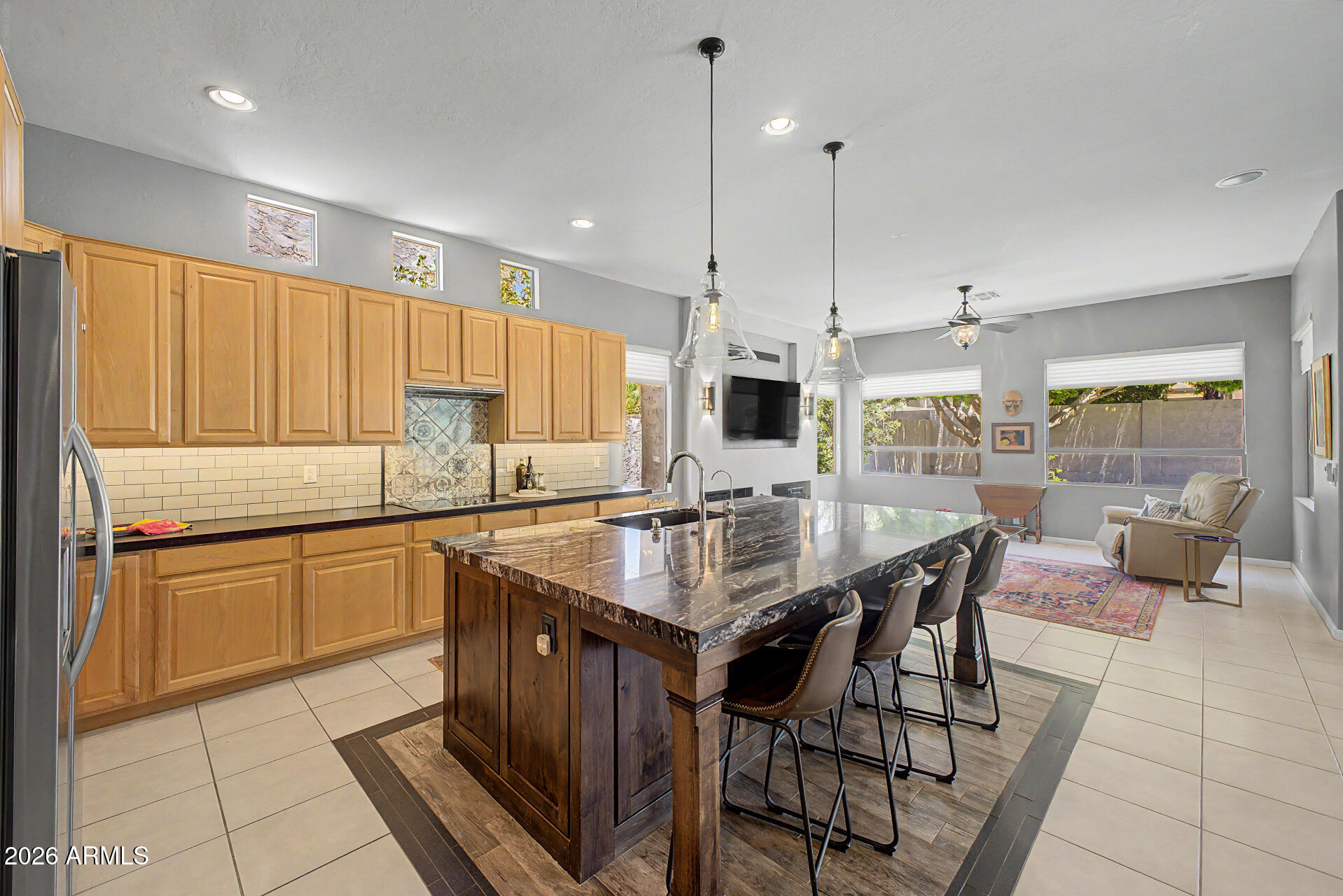 1632 West Frye Road Phoenix, AZ 85045 - Photo 4 of 37 a kitchen with granite countertop a table chairs stove a refrigerator and cabinets