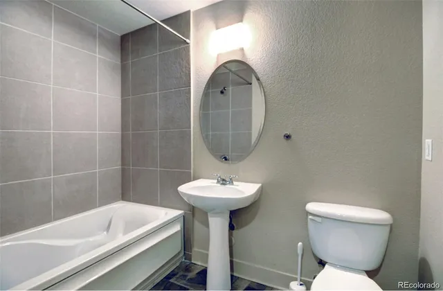 a bathroom with a sink a toilet and bathtub