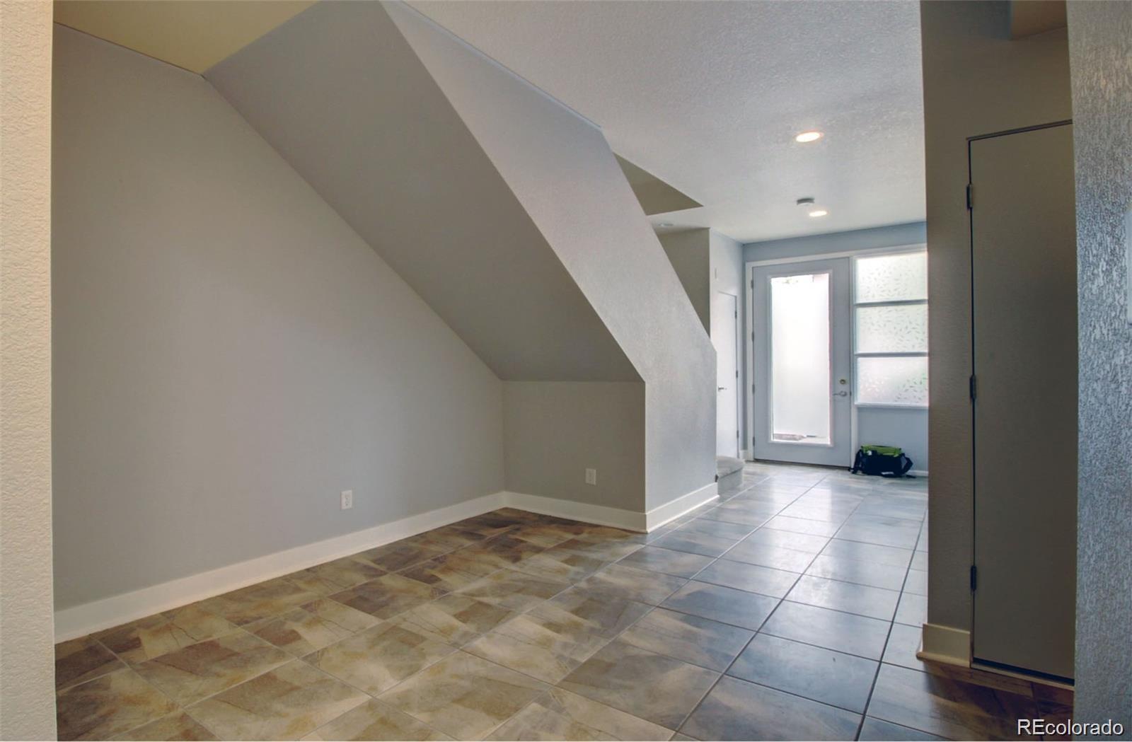2360 South Wheeling Circle Aurora, CO 80014 - Photo 13 of 26 a view of a big room with windows and chandelier