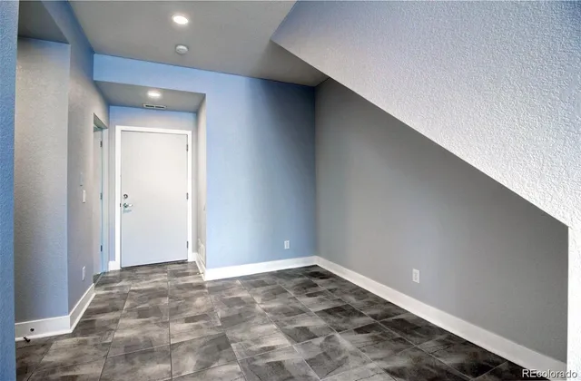 a view of a big room with wooden floor and cabinet