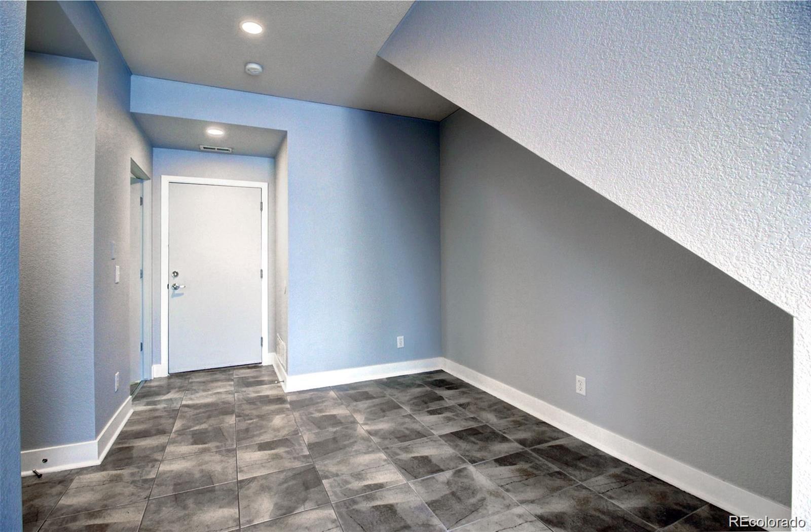 2360 South Wheeling Circle Aurora, CO 80014 - Photo 14 of 26 a view of a big room with wooden floor and cabinet