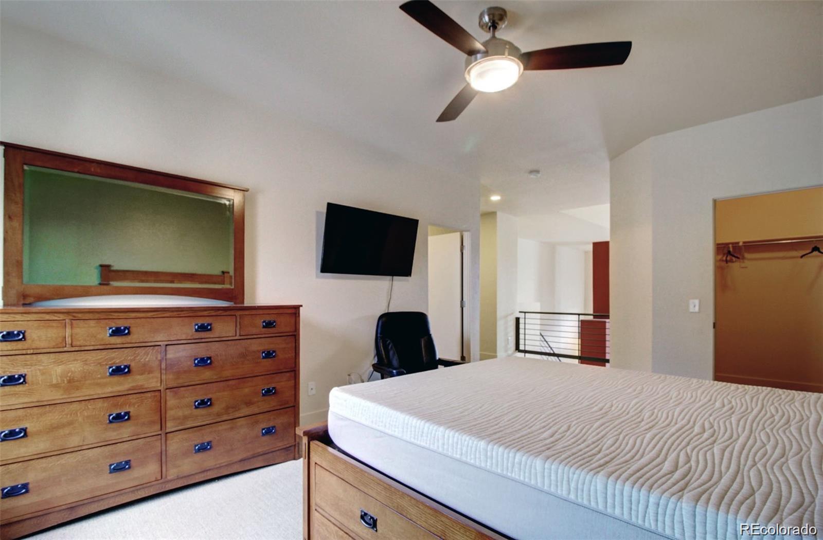 2360 South Wheeling Circle Aurora, CO 80014 - Photo 16 of 26 a bedroom with a bed and a flat screen tv