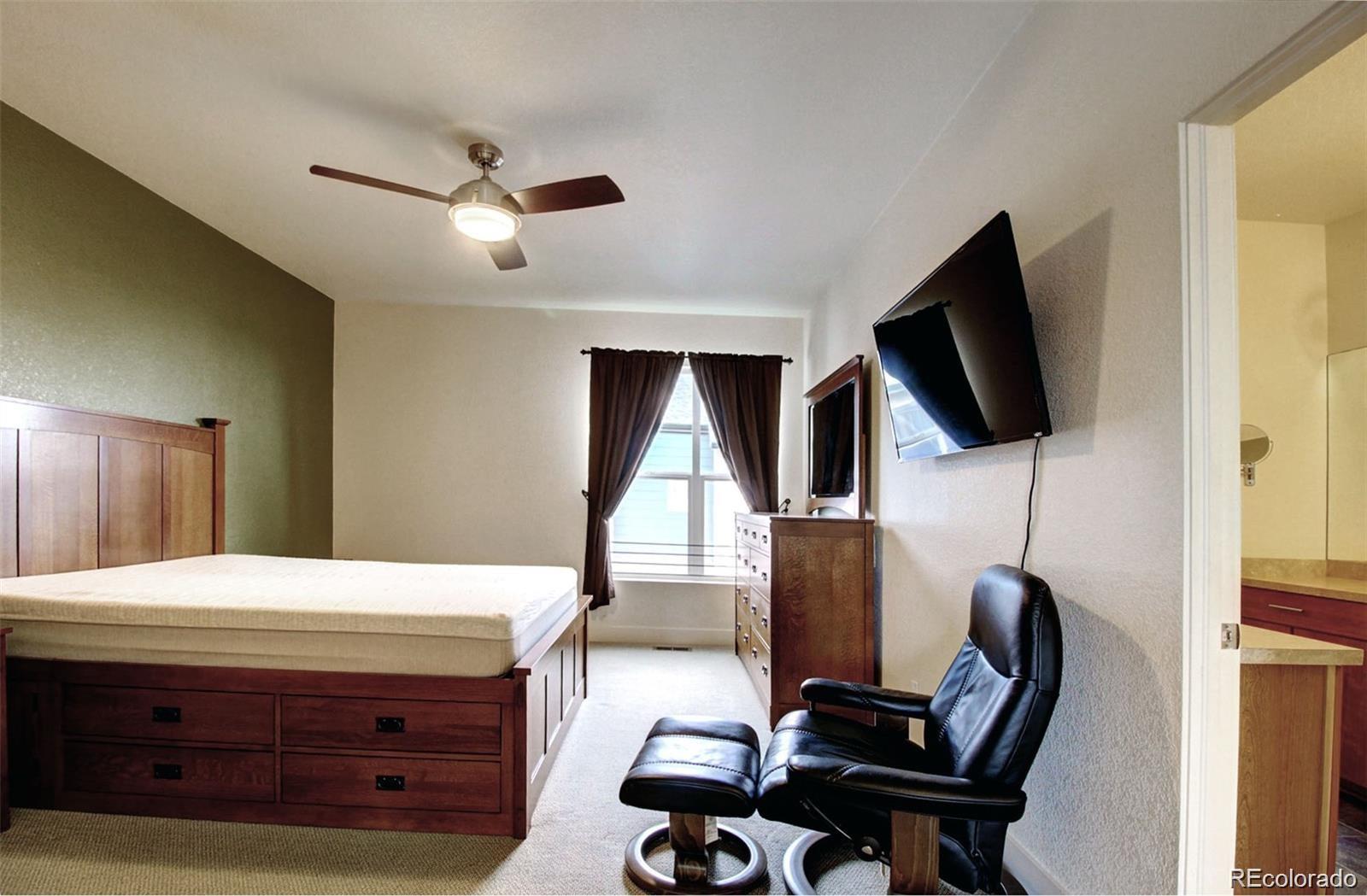 2360 South Wheeling Circle Aurora, CO 80014 - Photo 17 of 26 a room with furniture and a flat screen tv