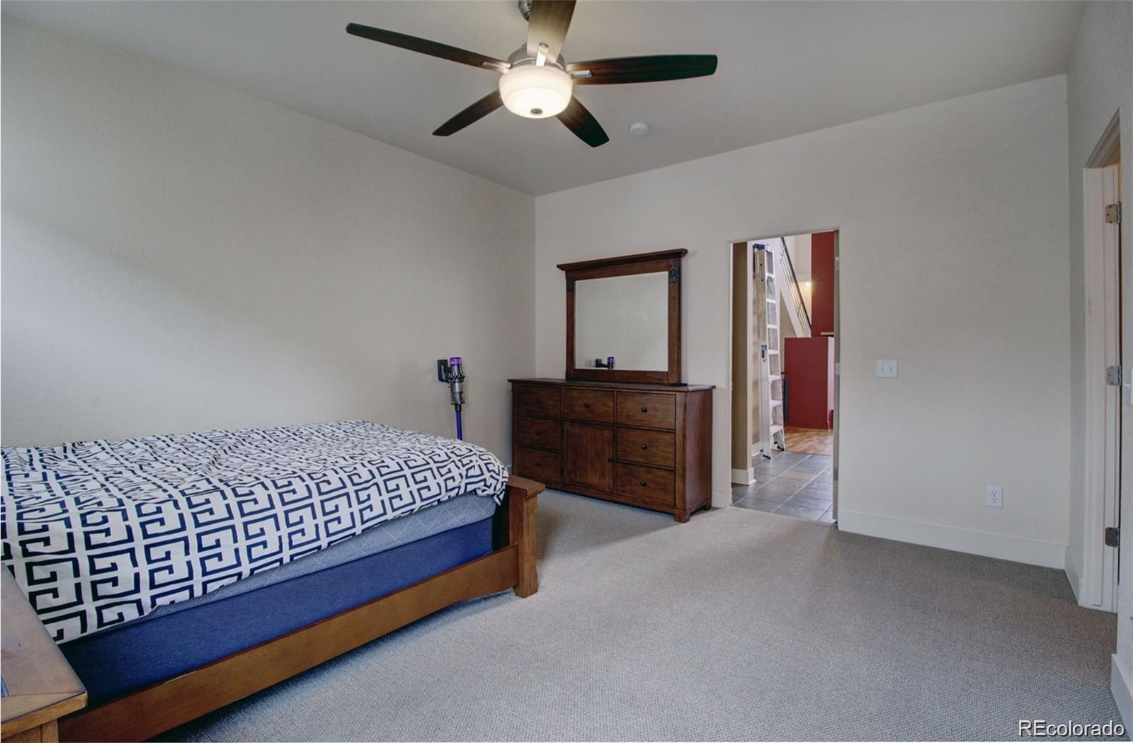 2360 South Wheeling Circle Aurora, CO 80014 - Photo 23 of 26 a bed sitting in a bedroom and dresser
