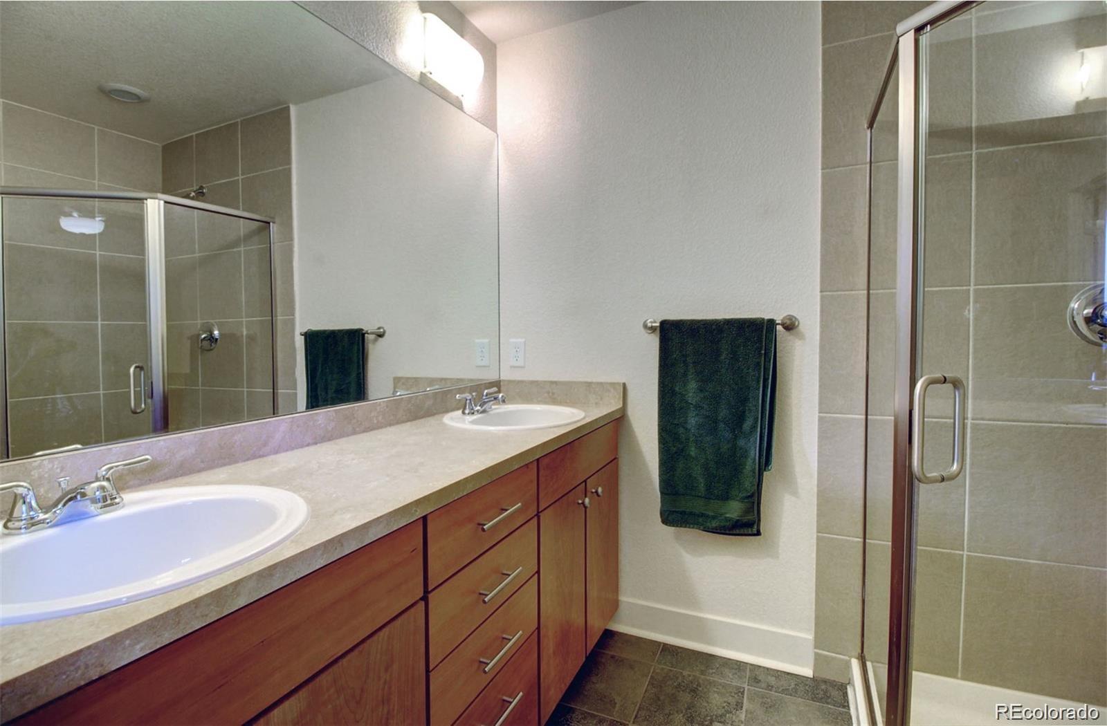 2360 South Wheeling Circle Aurora, CO 80014 - Photo 25 of 26 a bathroom with a granite countertop sink shower and mirror