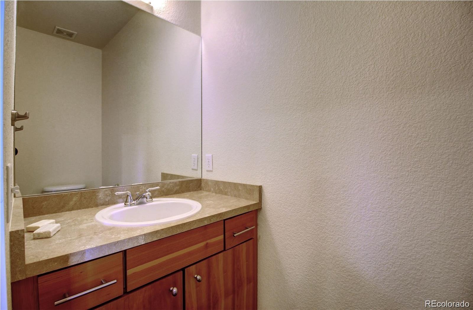 2360 South Wheeling Circle Aurora, CO 80014 - Photo 26 of 26 a bathroom with a sink and a mirror
