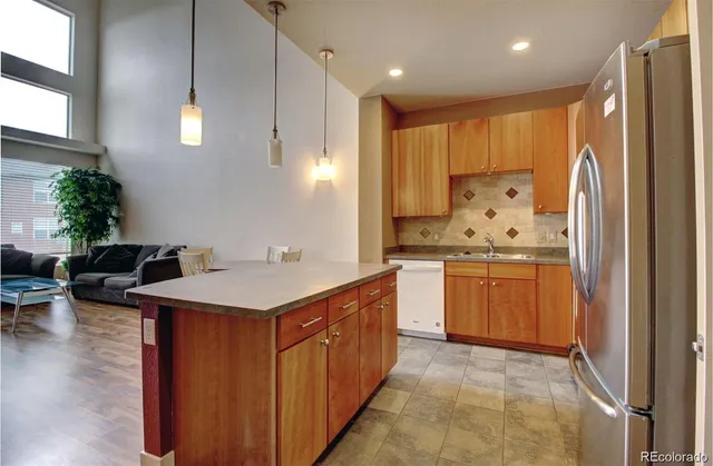 a kitchen with stainless steel appliances a sink stove and refrigerator