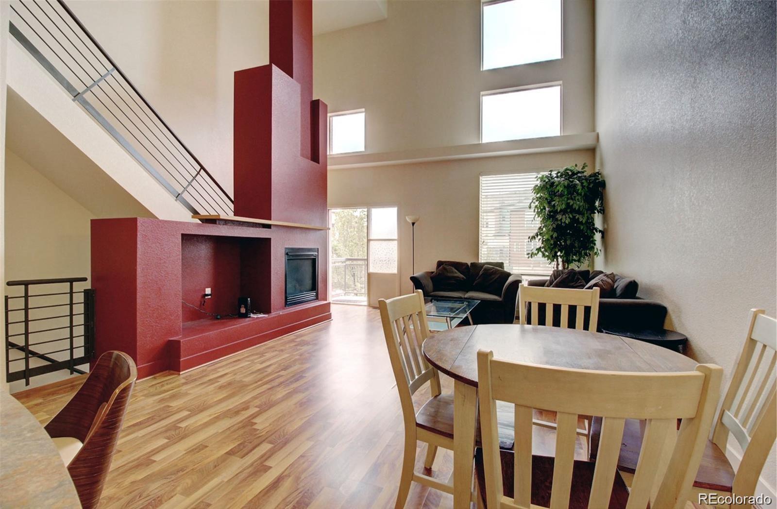 2360 South Wheeling Circle Aurora, CO 80014 - Photo 6 of 26 a view of a dining room with furniture and a fireplace