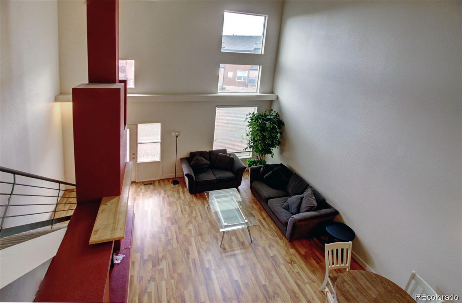 2360 South Wheeling Circle Aurora, CO 80014 - Photo 7 of 26 a living room with furniture and a wooden floor