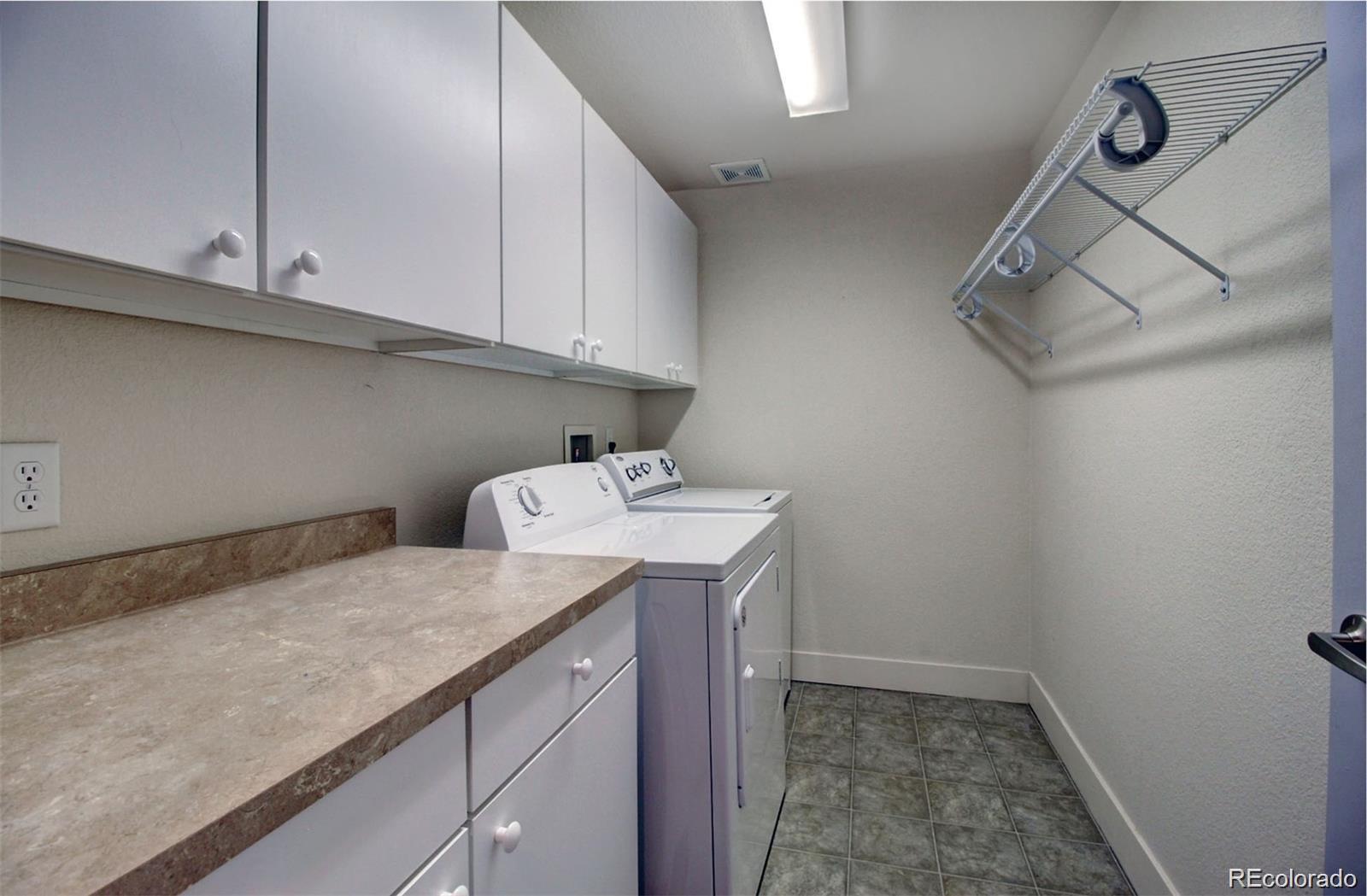 2360 South Wheeling Circle Aurora, CO 80014 - Photo 9 of 26 a utility room with cabinets