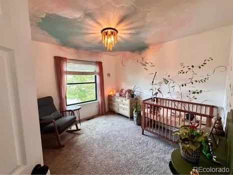 a spacious bedroom with a bed and a large mirror