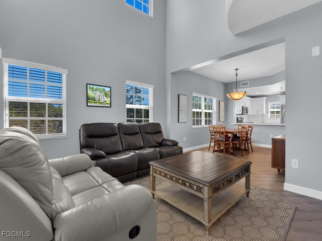 4500 Botanical Pl Circle, Unit 4 Naples, FL 34112 - Photo 12 of 43 a living room with furniture and a large window
