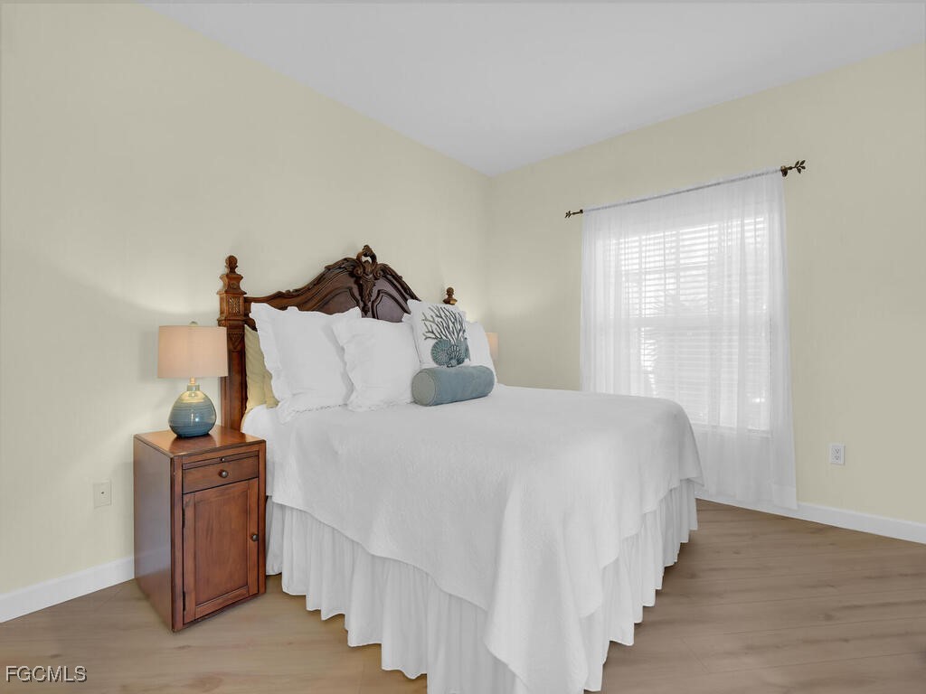 4500 Botanical Pl Circle, Unit 4 Naples, FL 34112 - Photo 13 of 43 a bedroom with a bed and a window