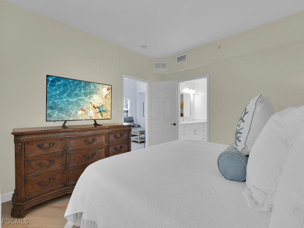 4500 Botanical Pl Circle, Unit 4 Naples, FL 34112 - Photo 14 of 43 a bed room with a bed and a dresser