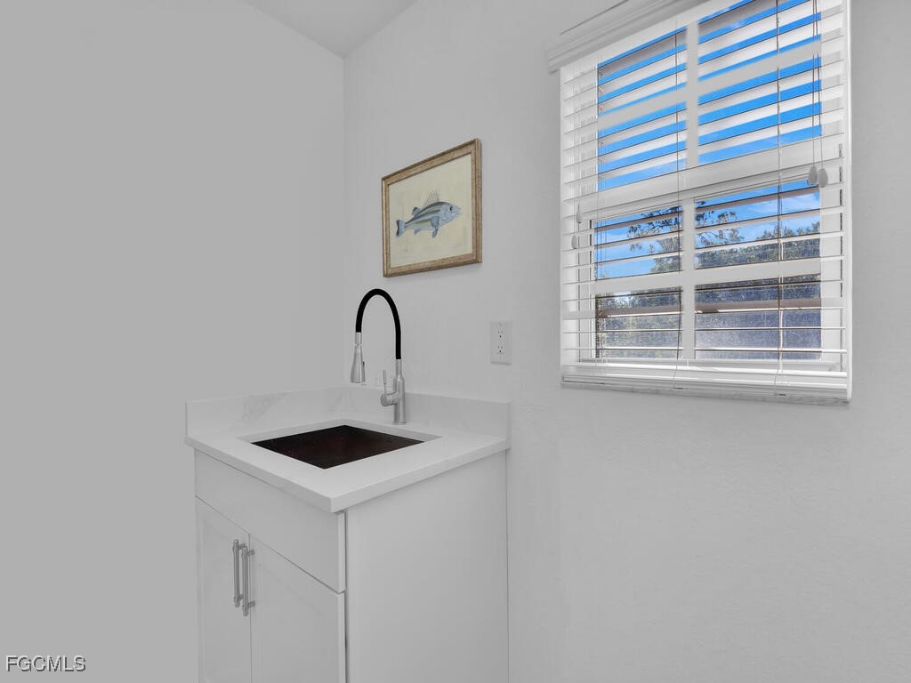 4500 Botanical Pl Circle, Unit 4 Naples, FL 34112 - Photo 18 of 43 a table and chair in a room