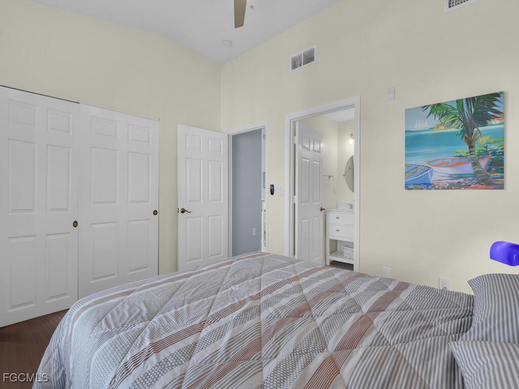 4500 Botanical Pl Circle, Unit 4 Naples, FL 34112 - Photo 27 of 43 a bedroom with a bed and a painting on the wall