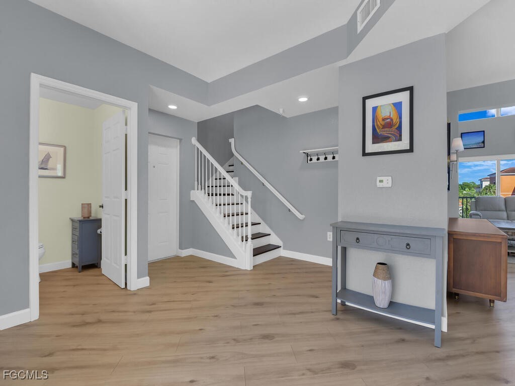 4500 Botanical Pl Circle, Unit 4 Naples, FL 34112 - Photo 3 of 43 a view of an entryway with wooden floor