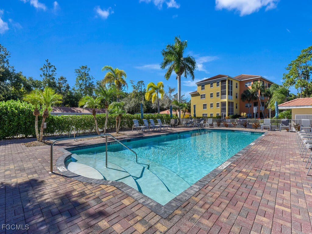 4500 Botanical Pl Circle, Unit 4 Naples, FL 34112 - Photo 34 of 43 a view of a swimming pool with a patio