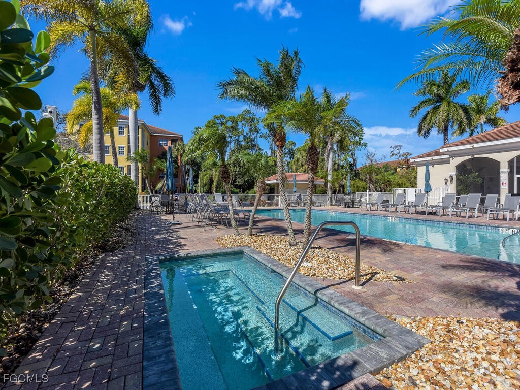 4500 Botanical Pl Circle, Unit 4 Naples, FL 34112 - Photo 35 of 43 a view of a swimming pool with a patio