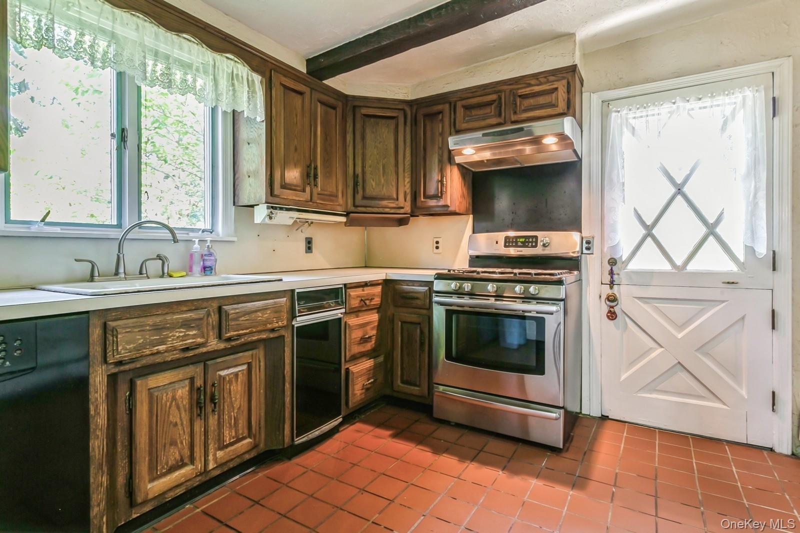 444 Milton Road Rye, NY 10580 - Photo 5 of 23 a kitchen with stainless steel appliances a stove sink and cabinets