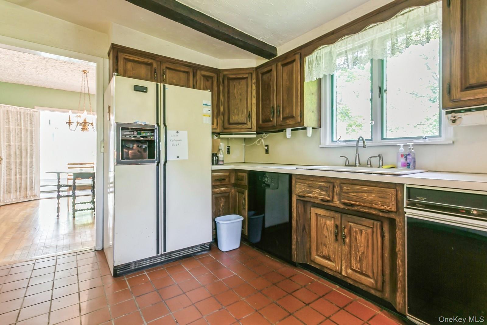 444 Milton Road Rye, NY 10580 - Photo 6 of 23 a kitchen with stainless steel appliances a sink cabinets and a refrigerator