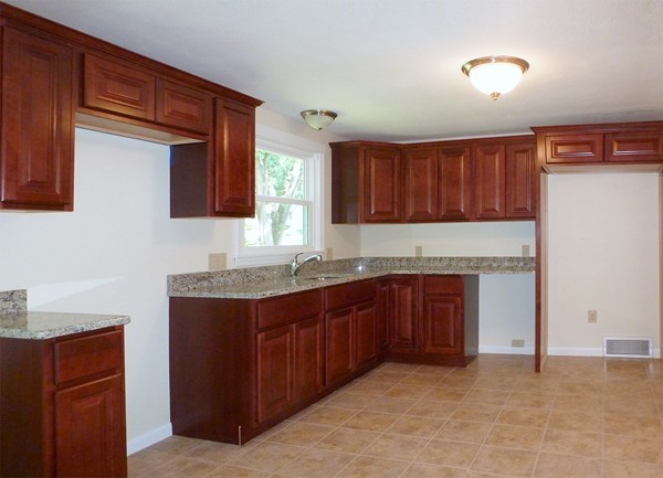 60 Jeanne Marie Street Springfield, MA 01129 - Photo 3 of 20 a kitchen with stainless steel appliances granite countertop a stove cabinets and a sink