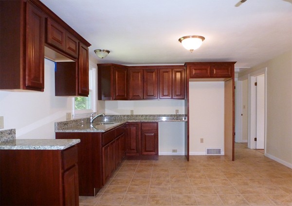 60 Jeanne Marie Street Springfield, MA 01129 - Photo 7 of 20 a kitchen with stainless steel appliances granite countertop a sink stove and refrigerator