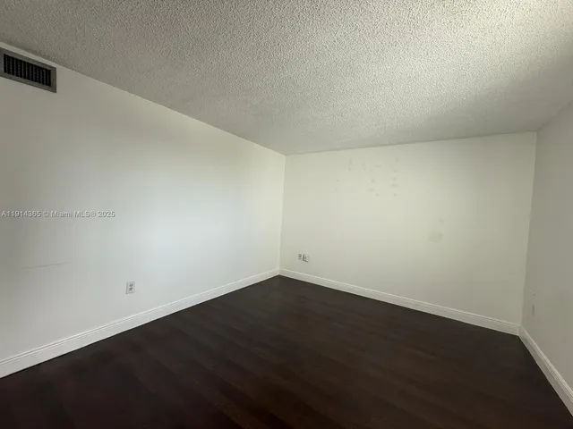 a view of walk in closet with wooden floor