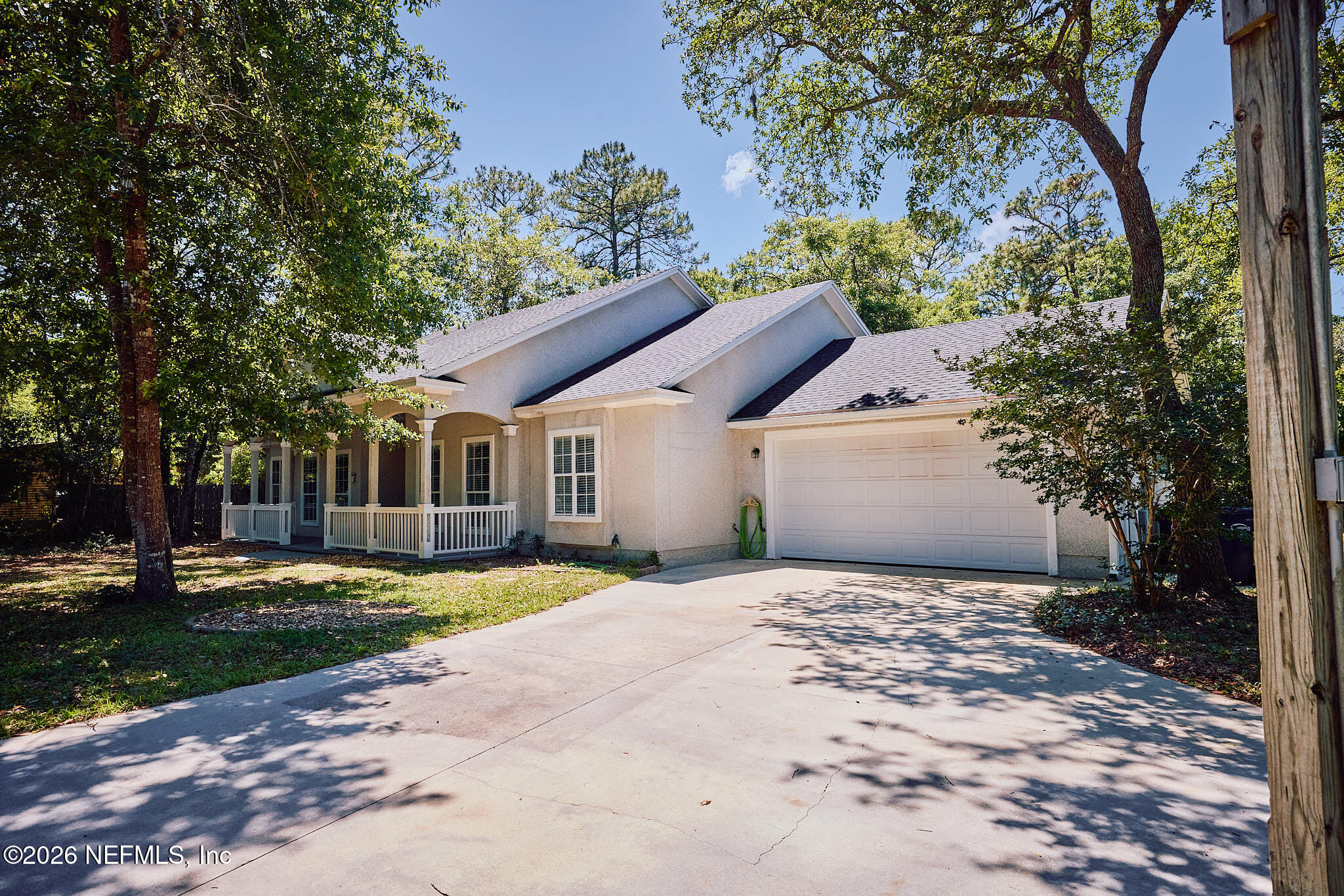 85404 Burmeister Road Fernandina Beach, FL 32034 - Photo 5 of 53 a front view of a house with a yard and garage