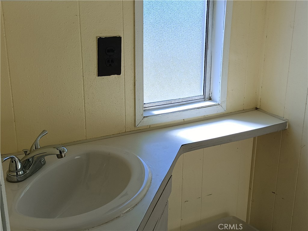 2100 Soapmine Road, Unit 44 Barstow, CA 92311 - Photo 11 of 17 a bathroom with a sink and mirror