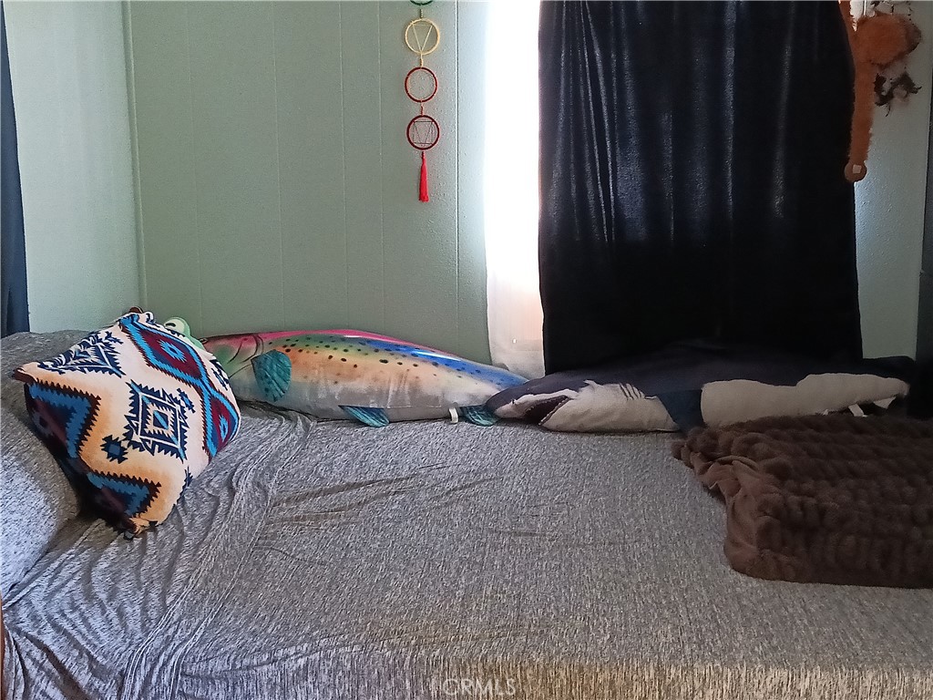 2100 Soapmine Road, Unit 44 Barstow, CA 92311 - Photo 15 of 17 a bedroom with bed and a window