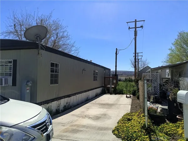a backyard of a house with table and chairs