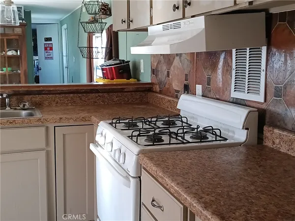a kitchen with a stove and a sink