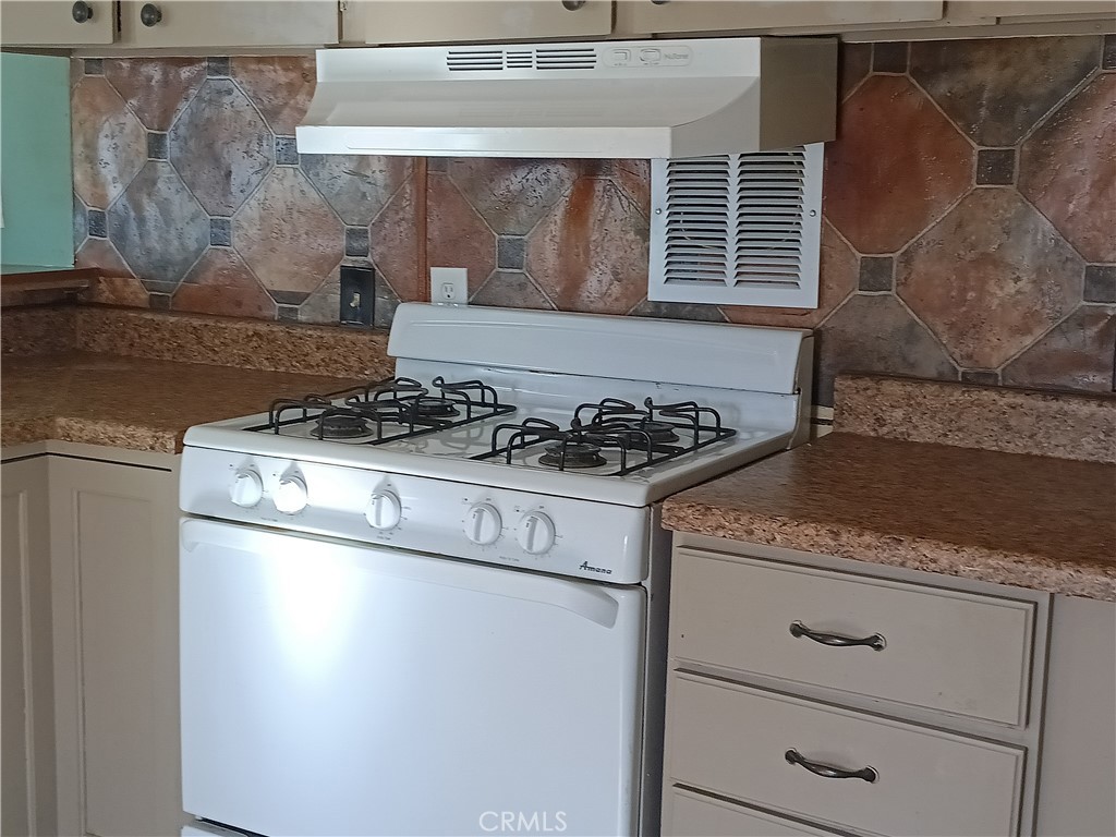 2100 Soapmine Road, Unit 44 Barstow, CA 92311 - Photo 9 of 17 a white stove top oven sitting inside of a kitchen