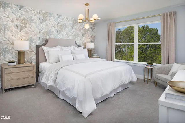 a bed room with a bed and a chair