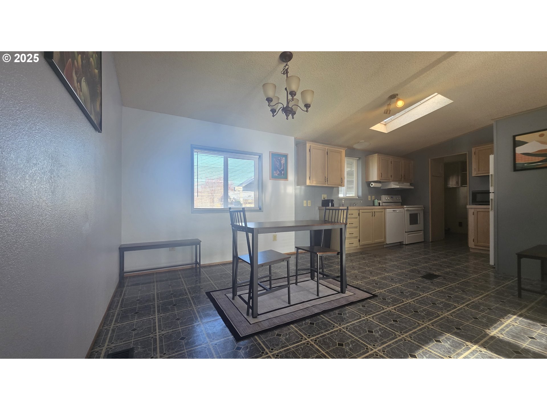 1500 South Columbus Avenue, Unit 38 Goldendale, WA 98620 - Photo 12 of 30 a kitchen with a table chairs refrigerator and microwave