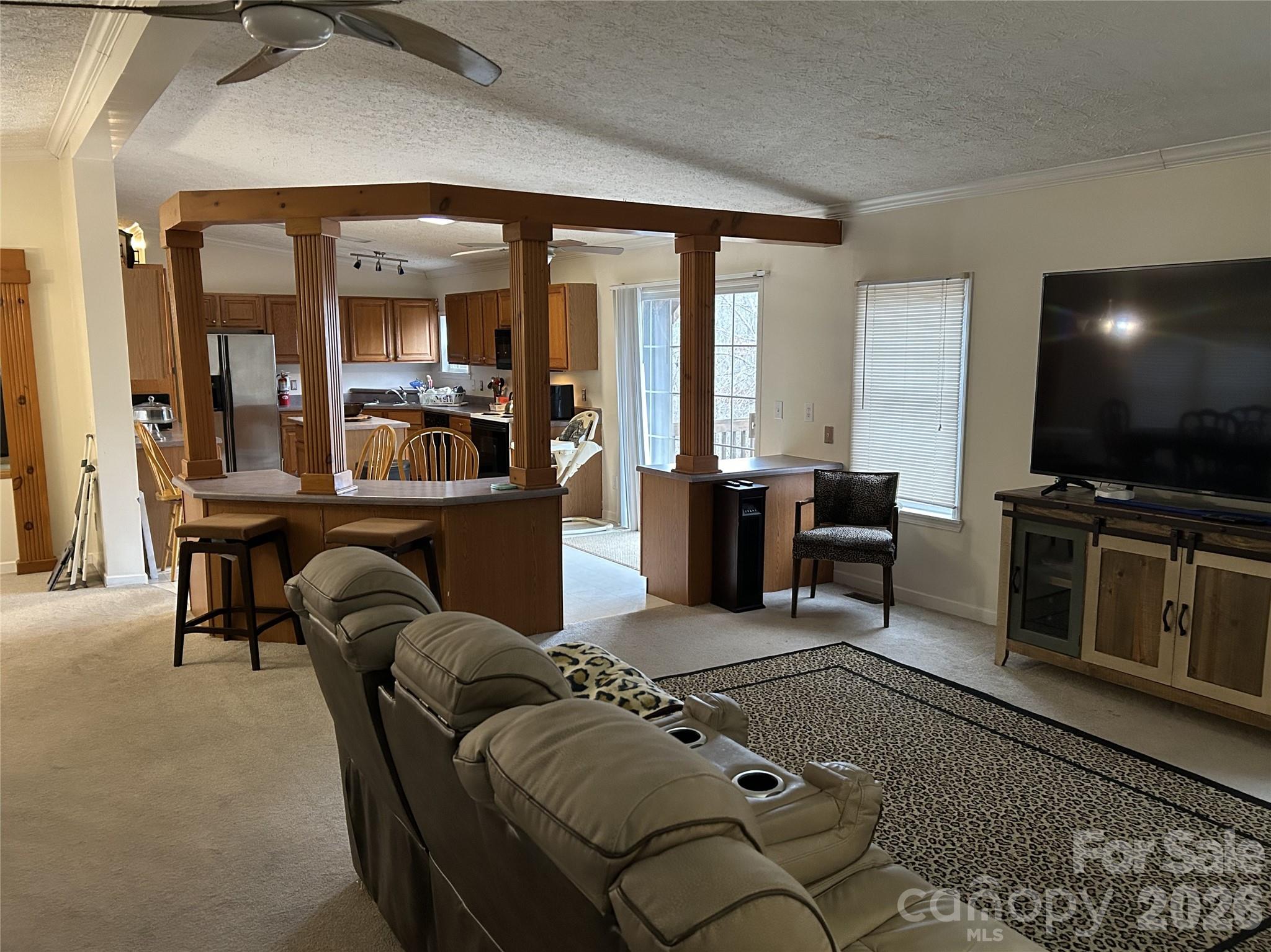 322 Balmy Lane Rutherfordton, NC 28139 - Photo 10 of 34 a living room with furniture a flat screen tv and large windows