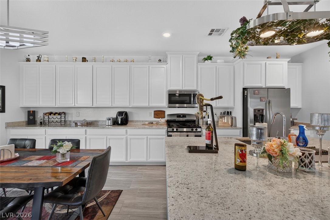 1824 Redland Ridge Street Henderson, NV 89002 - Photo 18 of 69 White cabinetry and light granite counters complete this well-lit kitchen, perfect for entertaining.