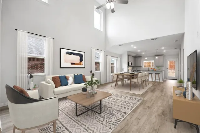 a living room with fireplace furniture and a table