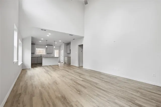 a view of kitchen and hallway with wooden floor