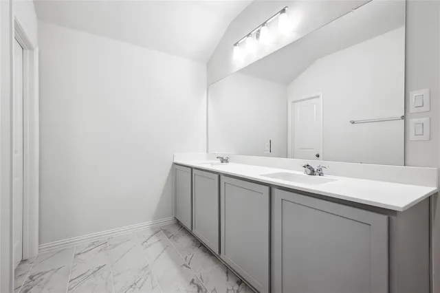 a bathroom with a sink and mirror