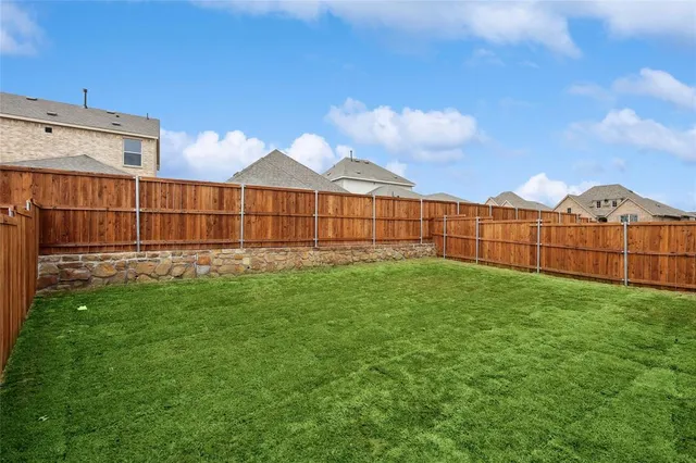 a view of a backyard with a garden and deck