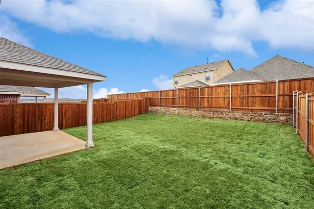 a view of a backyard with a garden and plants