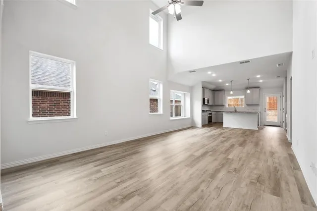 a view of kitchen and hall with wooden floor and a kitchen