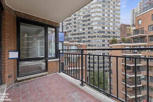 a view of a balcony with a floor to ceiling window