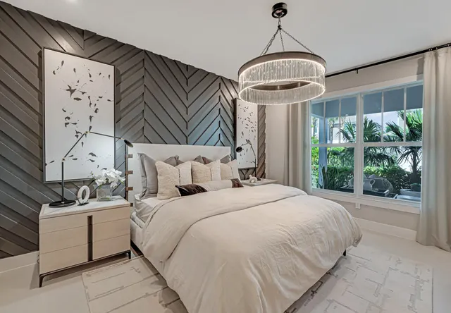 a living room with furniture and floor to ceiling window