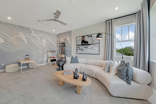 a front view of a house with a yard and potted plants