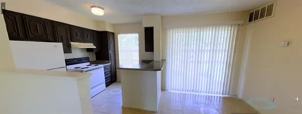 a kitchen with stainless steel appliances wooden cabinets and a refrigerator