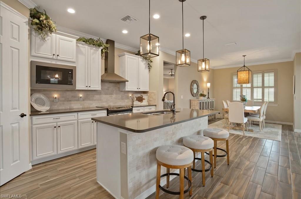 10809 Dennington Road Fort Myers, FL 33913 - Photo 12 of 30 a kitchen with sink cabinets and wooden floor