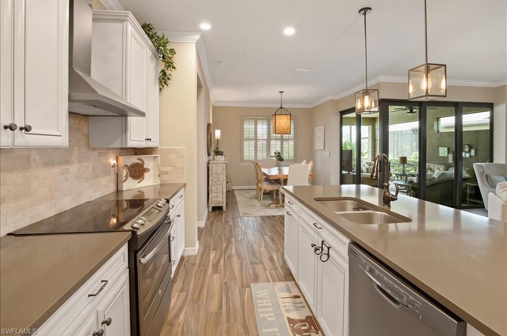10809 Dennington Road Fort Myers, FL 33913 - Photo 14 of 30 a open kitchen with stainless steel appliances granite countertop a lot of counter space and a wooden floors